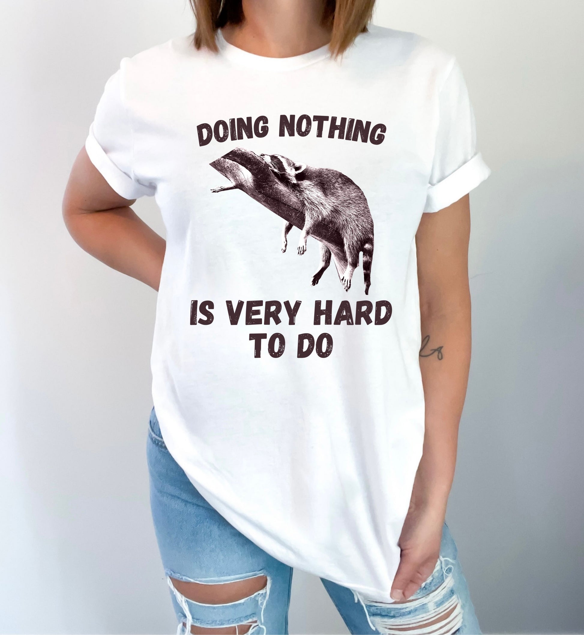 Cute Raccoon Graphic Tee – 'Doing Nothing Is Very Hard to Do' – Funny Unisex T-Shirt-White-Family-Gift-Planet